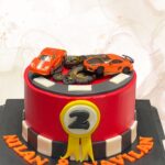 Race car-themed birthday cake, sporty car cake, custom racing cake Singapore, designer cakes for kids, LE PETIT EMPIRE cake design.