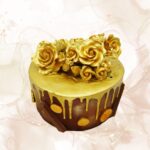 Gold roses cake with chocolate and gold accents for special celebrations.