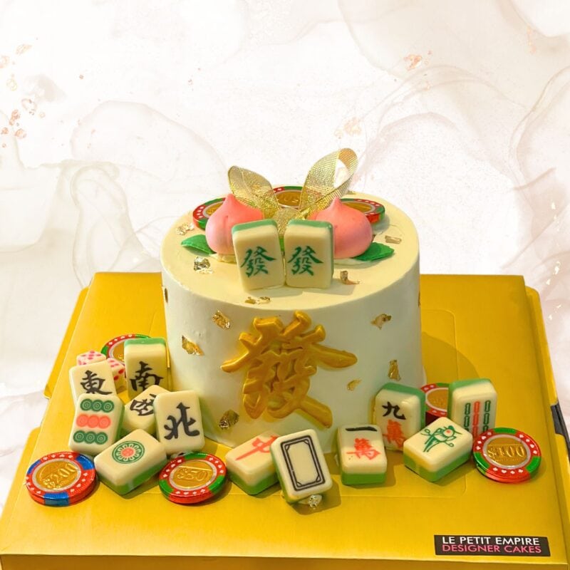 Mahjong themed celebration cake with intricate details, edible mahjong tiles, and gold accents for special occasions.
