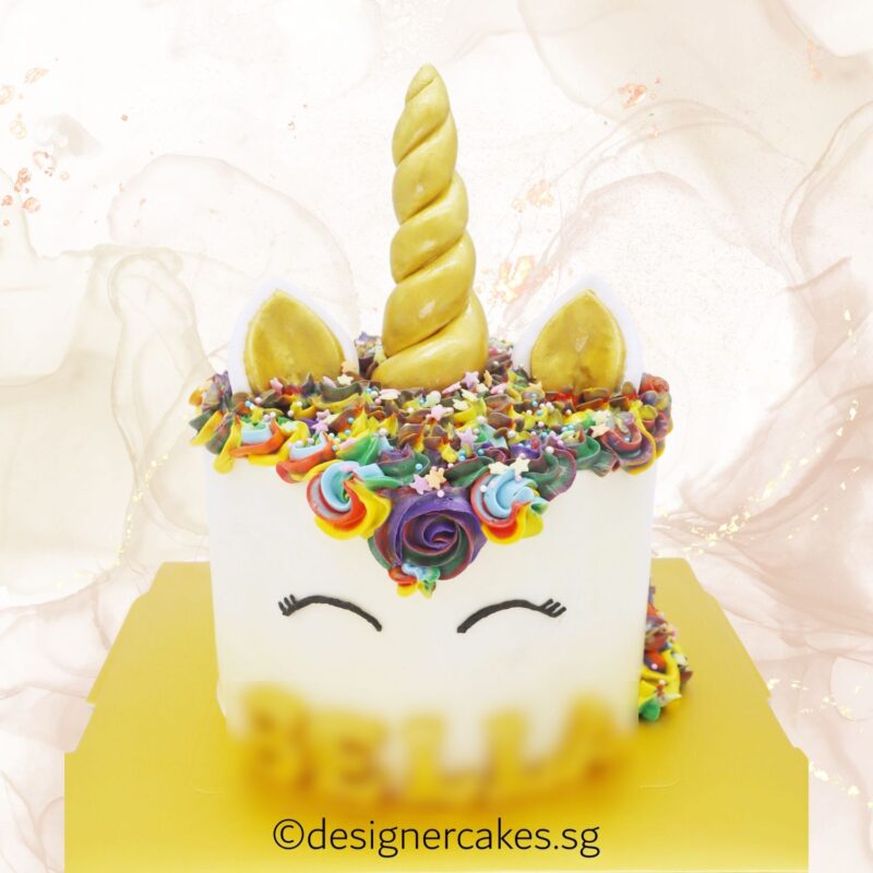 Colorful unicorn-themed cake with rainbow floral decorations, perfect for special celebrations, by LE PETIT EMPIRE Designer Cakes.
