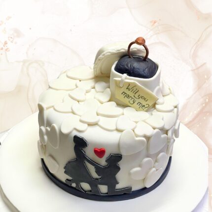 Elegant romantic wedding cake with white heart decorations and a silhouette couple topper, perfect for modern wedding celebrations.