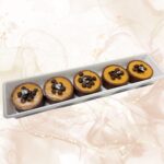 Choco Mango Tart, decadent dessert with chocolate, mango, and silver leaf garnish. Perfect for special occasions or elegant treats.